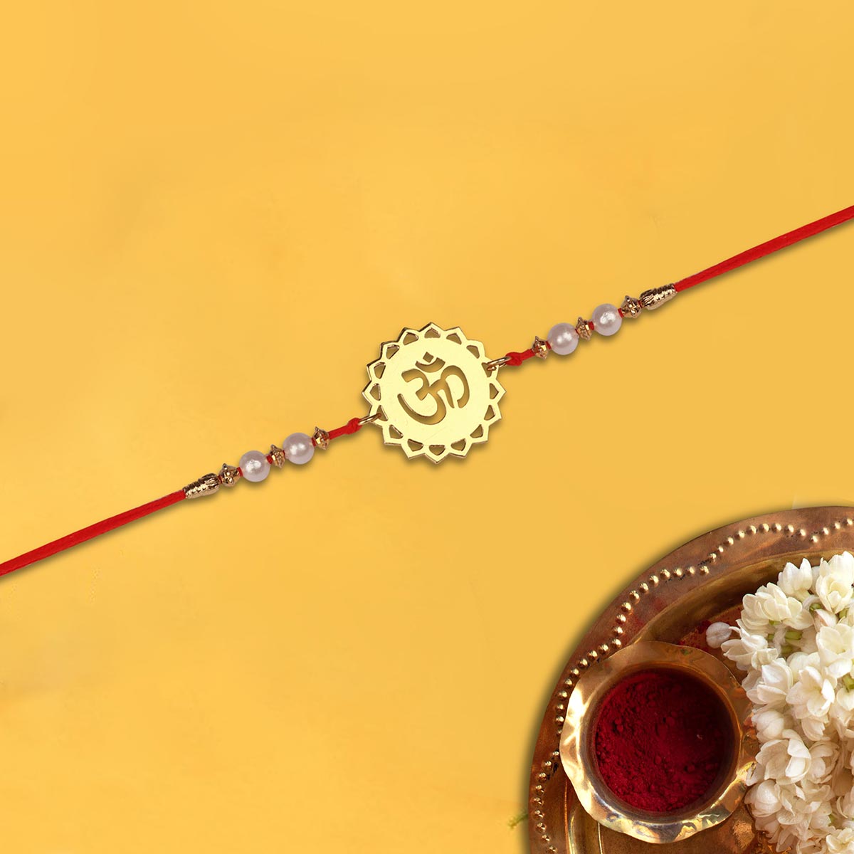 Divine Om Metal Rakhi With Pearl Beads